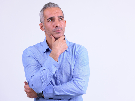 Portrait of handsome Persian businessman thinking and looking upの写真素材