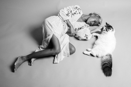 Young beautiful rebellious woman with short hair with Persianの写真素材