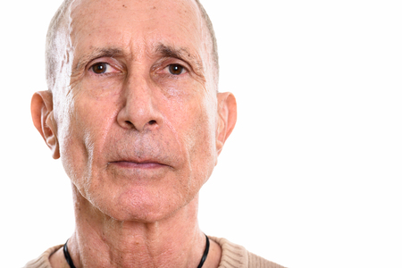 Close up of senior man face isolated against white backgroundの写真素材
