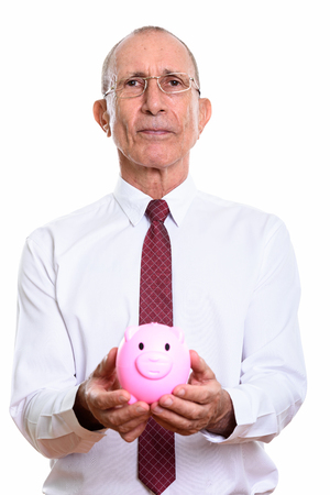 Studio shot of senior businessman holding piggy bankの写真素材