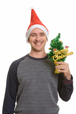 Happy Caucasian man holding Merry Christmas treeの写真素材