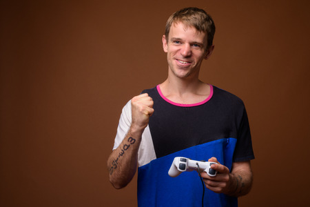 Man playing video games using game controllerの写真素材