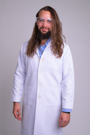 Young bearded man doctor with protective glassesの写真素材