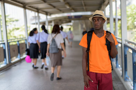 Black African tourist man standing and thinking at the footbridgeの写真素材