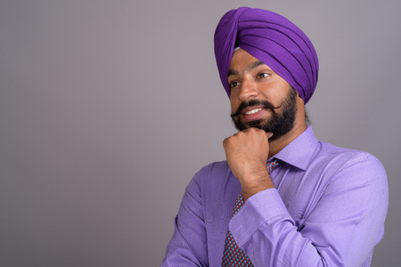 Indian Sikh businessman wearing turban while thinkingの写真素材