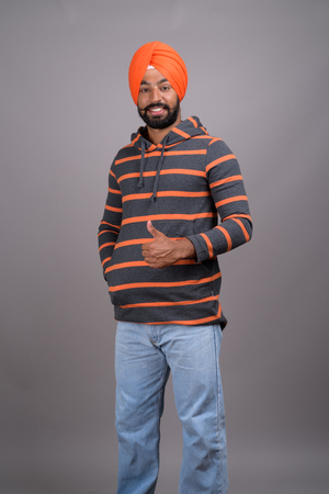 Full length shot of young handsome Indian Sikh man with turbanの写真素材