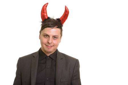 Studio shot of happy Caucasian businessman wearing devil hornsの写真素材
