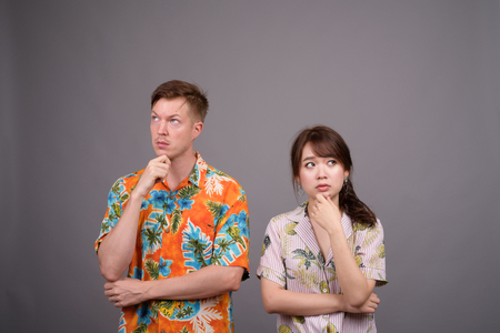 Portrait of multi ethnic tourist couple thinking and planningの写真素材