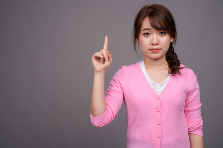 Young beautiful Asian woman wearing pink shirtの写真素材