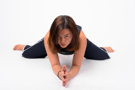 Full body shot of young beautiful Asian woman stretchingの写真素材