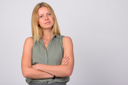 Portrait of young beautiful blonde businesswoman with arms crossedの写真素材
