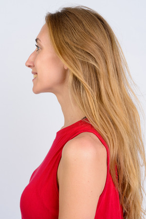 Head shot profile view of young happy blonde woman smilingの写真素材