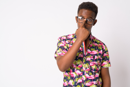 Portrait of young African tourist man adjusting eyeglassesの写真素材