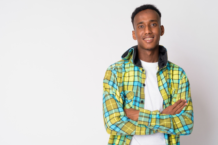 Portrait of young happy African hipster man smiling with arms crossedの写真素材
