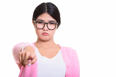 Studio Portrait Of Young Asian Woman Isolated Against White Backgroundの写真素材