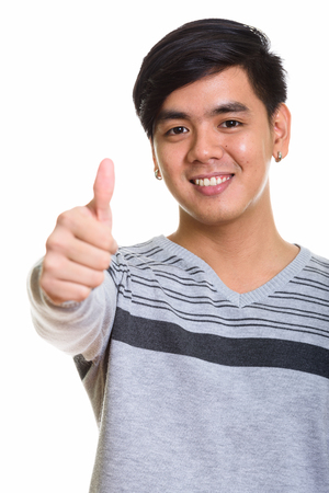 Close up of happy Asian man smiling and giving thumb upの写真素材