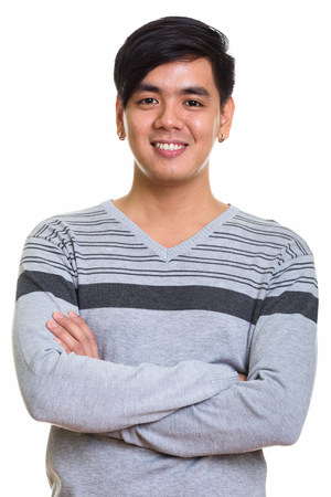 Studio shot of happy Asian man smiling with arms crossedの写真素材