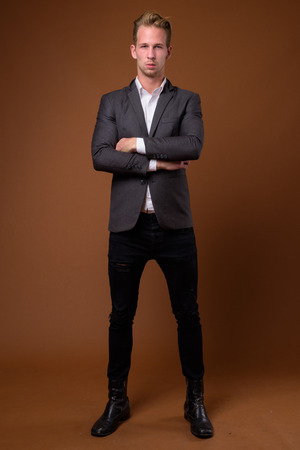 Studio portrait of young handsome businessman with suitの写真素材