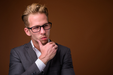 Studio portrait of young handsome businessman with suitの写真素材