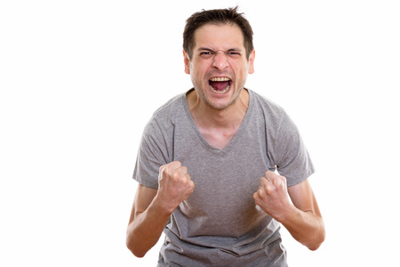 Studio shot of happy young man smiling while looking excitedの写真素材
