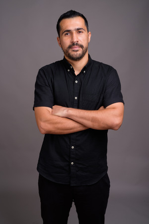 Handsome bearded Persian man against gray backgroundの写真素材