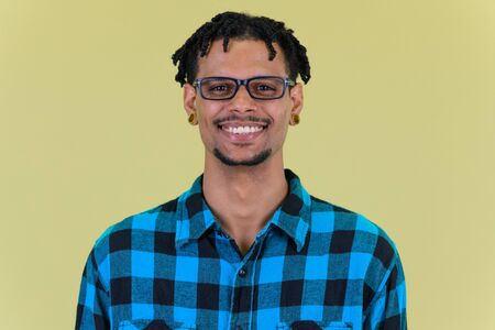 Face of happy young African hipster man smiling