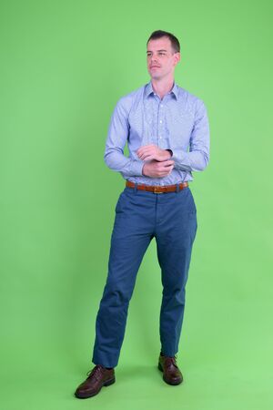 Full body shot of businessman against green backgroundの写真素材