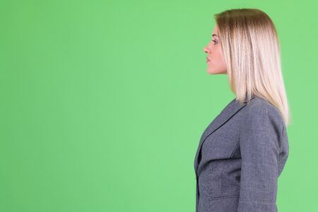 Profile view of young beautiful blonde businesswomanの写真素材