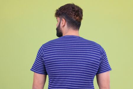 Rear view of young overweight bearded Indian manの写真素材