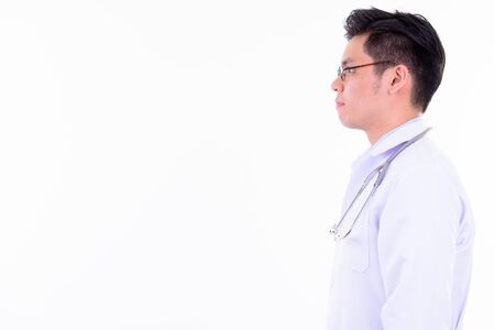 Profile view of young handsome Asian man doctorの写真素材