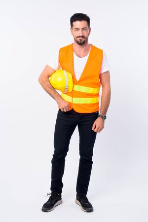 Full body shot of young bearded man construction workerの写真素材