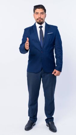 Full body shot of bearded Persian businessman giving handshakeの写真素材