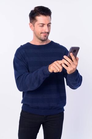 Portrait of handsome bearded man using phoneの写真素材