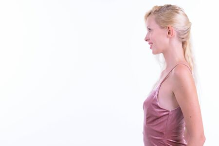 Profile view of happy young beautiful blonde woman smilingの写真素材