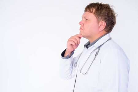 Closeup profile view of overweight man doctor thinkingの写真素材