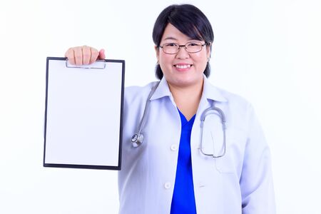 Happy overweight Asian woman doctor showing clipboardの写真素材