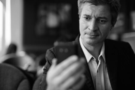 Businessman relaxing at the coffee shop in Bangkok, Thailandの写真素材