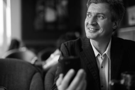Businessman relaxing at the coffee shop in Bangkok, Thailandの写真素材