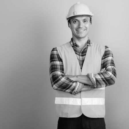 Man construction worker against gray background shot in black and white