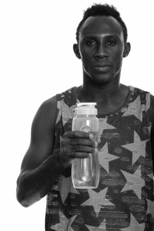 Young black African man holding water bottleの写真素材