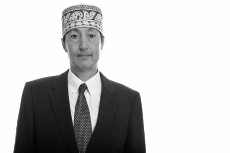 Studio shot of mature businessman wearing traditional ethnic hat