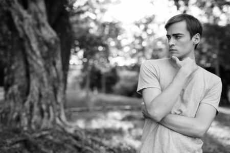 Young handsome man relaxing at the parkの写真素材