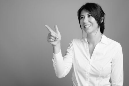 Portrait of young beautiful businesswoman shot in black and whiteの写真素材