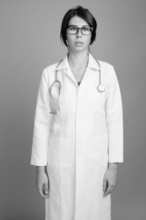 Portrait of young woman doctor shot in black and whiteの写真素材