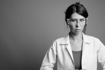 Scientist doctor wearing protective glasses shot in black and whiteの写真素材