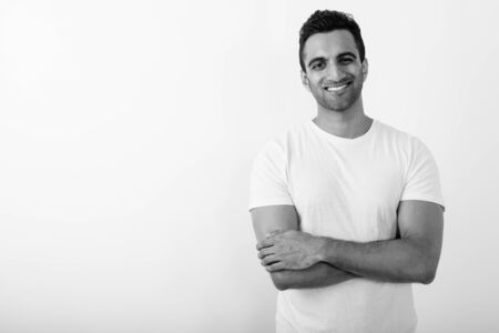 Young handsome Indian man against white backgroundの写真素材