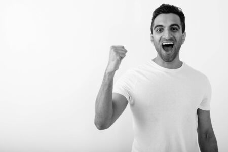 Young handsome Indian man against white backgroundの写真素材