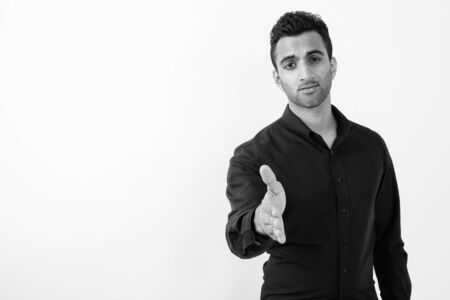 Young handsome Indian businessman against white backgroundの写真素材
