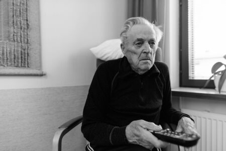 Senior man relaxing at nursing home in Turku, Finlandの写真素材