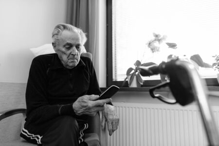 Senior man relaxing at nursing home in Turku, Finlandの写真素材